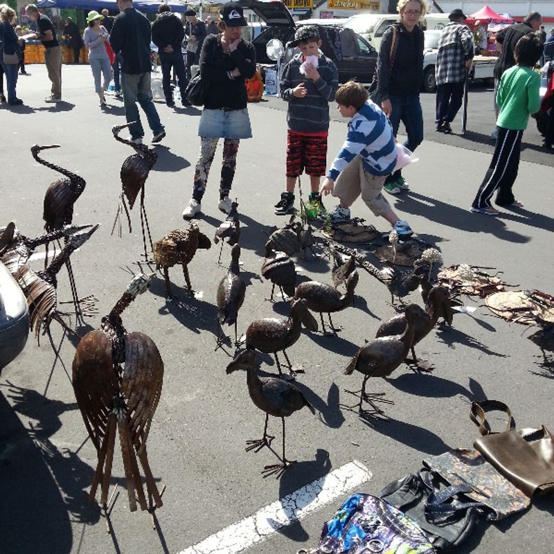 A stallholder arranging artwork.