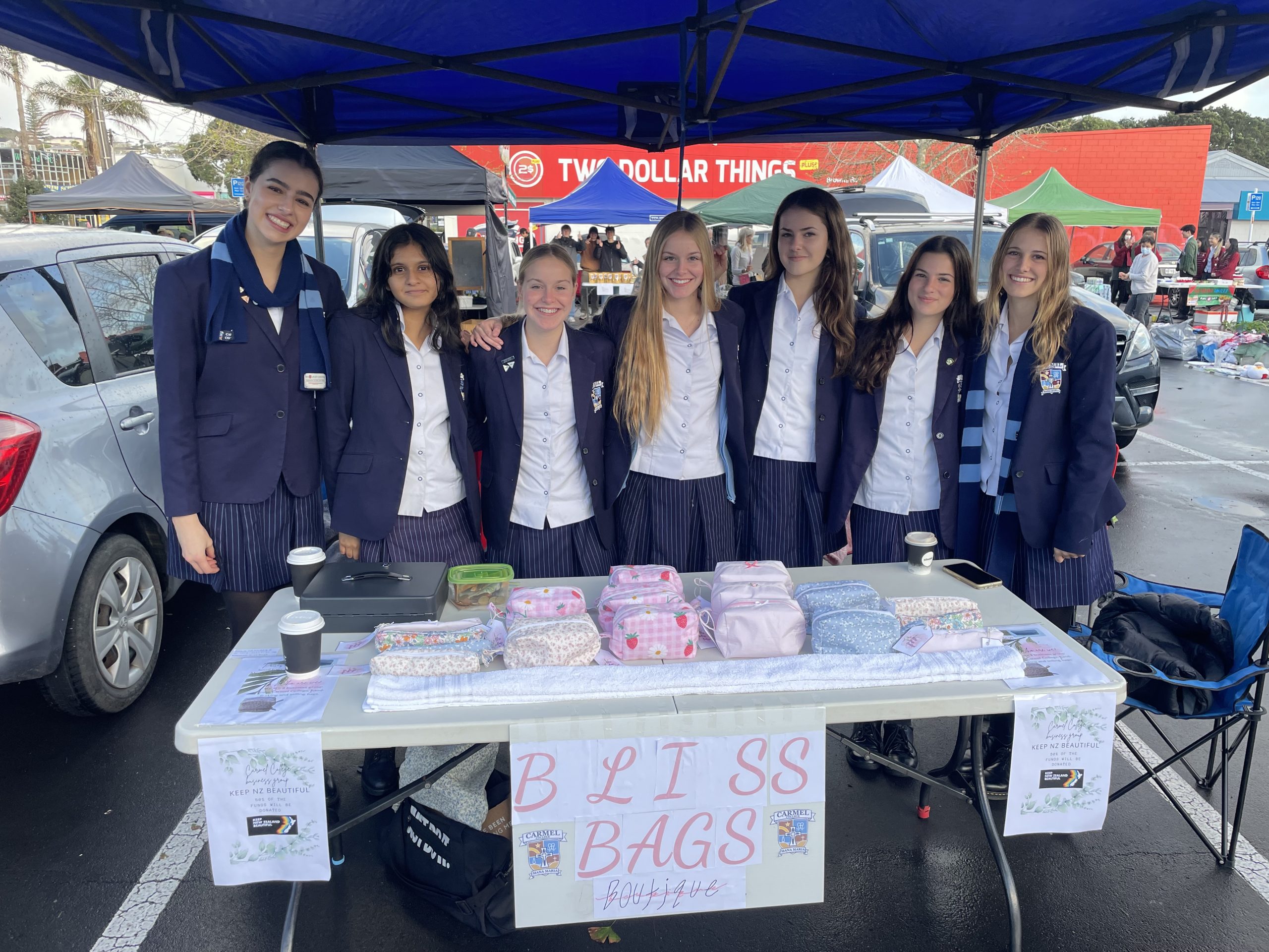 A group of college students running a stall at the market.