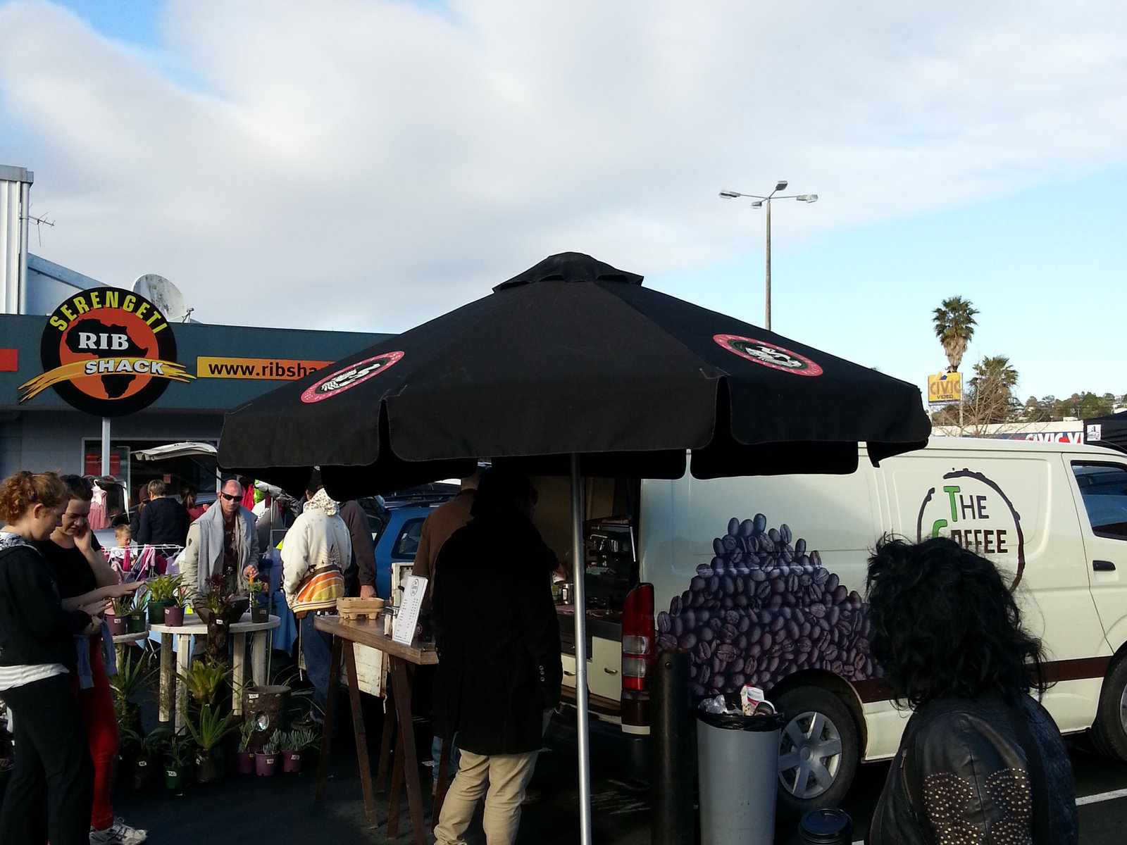 A takeaway coffee cup and pastry from a nearby Browns Bay café.