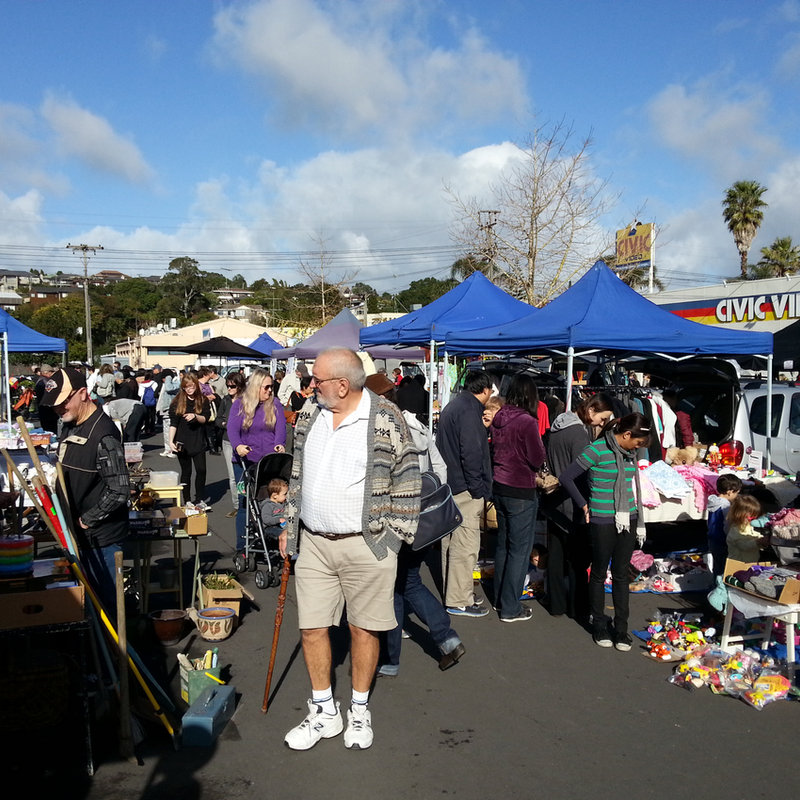A stallholder arranging handmade ceramics.