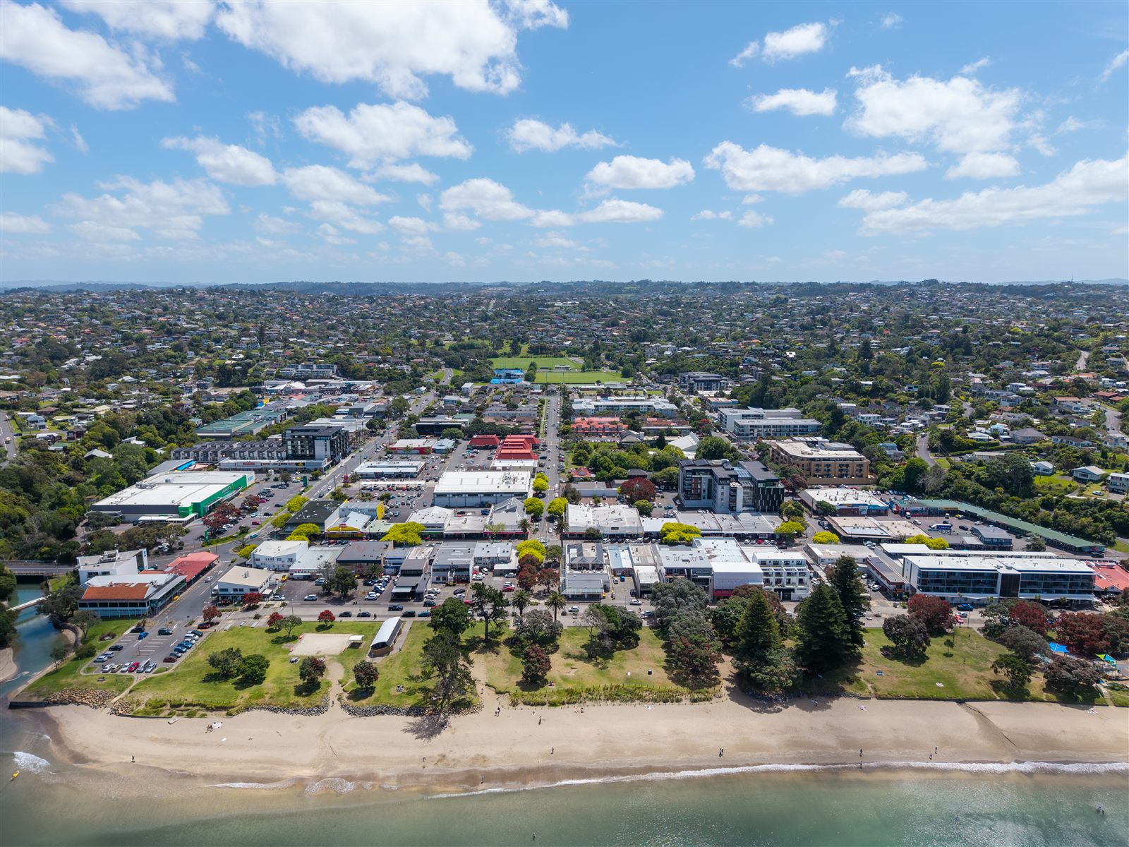 Aerial view of Browns Bay Sunday Market, with dozens of stalls filling the village carpark.